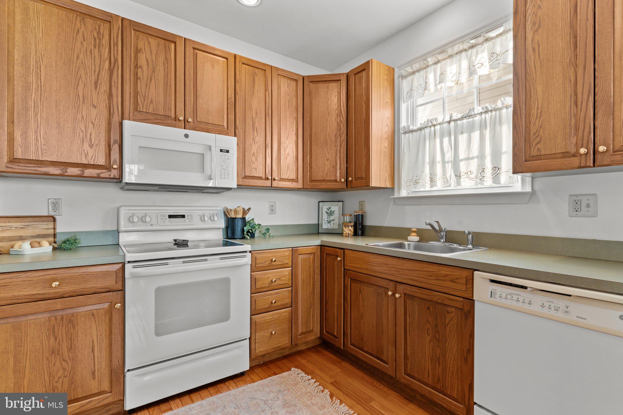 237 Beaumont Drive Oxford, PA 19363 - Photo 12 of 46 a kitchen with stainless steel appliances granite countertop a sink a stove and cabinets
