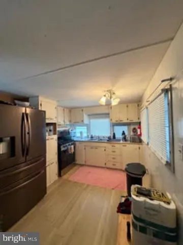 a kitchen with stainless steel appliances and refrigerator