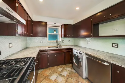 a kitchen with a sink stove and cabinets