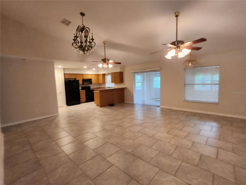 6521 East Grayson Street Inverness, FL 34452 - Photo 3 of 16 a view of a room with chandelier fan and kitchen view