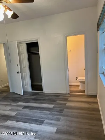 a view of wooden floor and windows