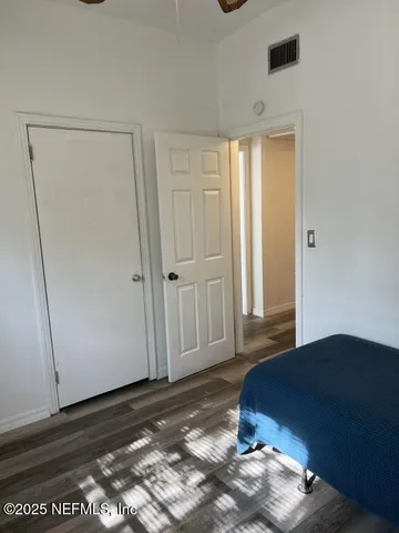 a view of a livingroom with wooden floor and cabinet