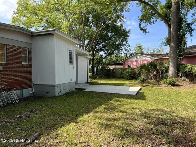 a view of a backyard with a large tree