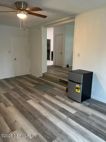 a living room with hard wood floors