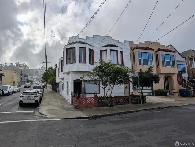 a city street lined with buildings and cars