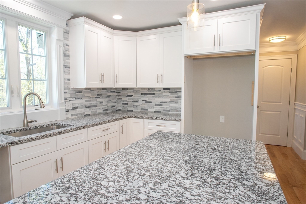 67 Willard Road Ashburnham, MA 01430 - Photo 16 of 42 a kitchen with granite countertop a sink and a stove