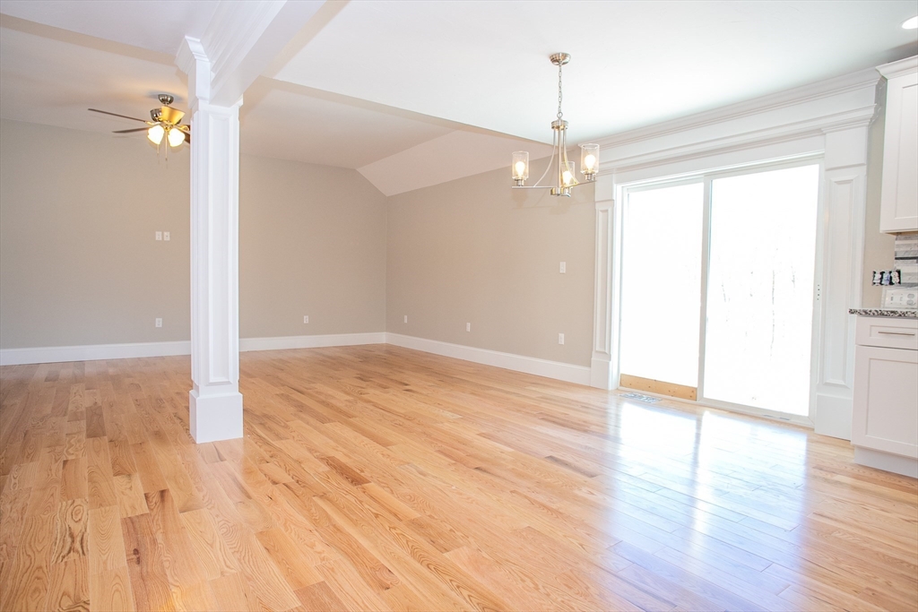 67 Willard Road Ashburnham, MA 01430 - Photo 22 of 42 an empty room with wooden floor chandelier and windows