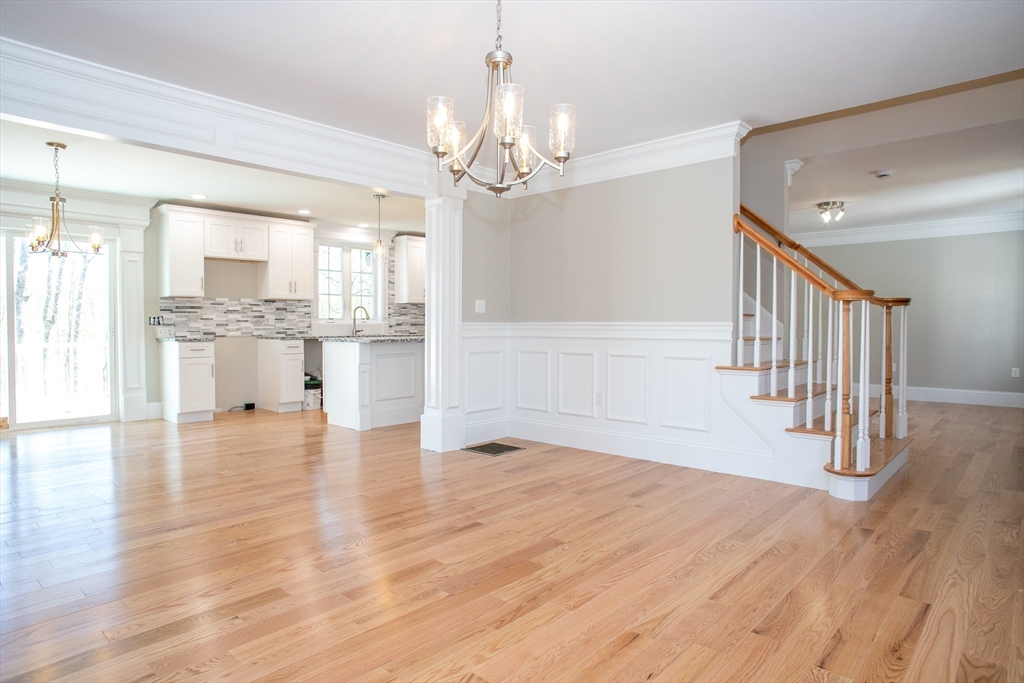67 Willard Road Ashburnham, MA 01430 - Photo 28 of 42 a view of an empty room and kitchen with wooden floor