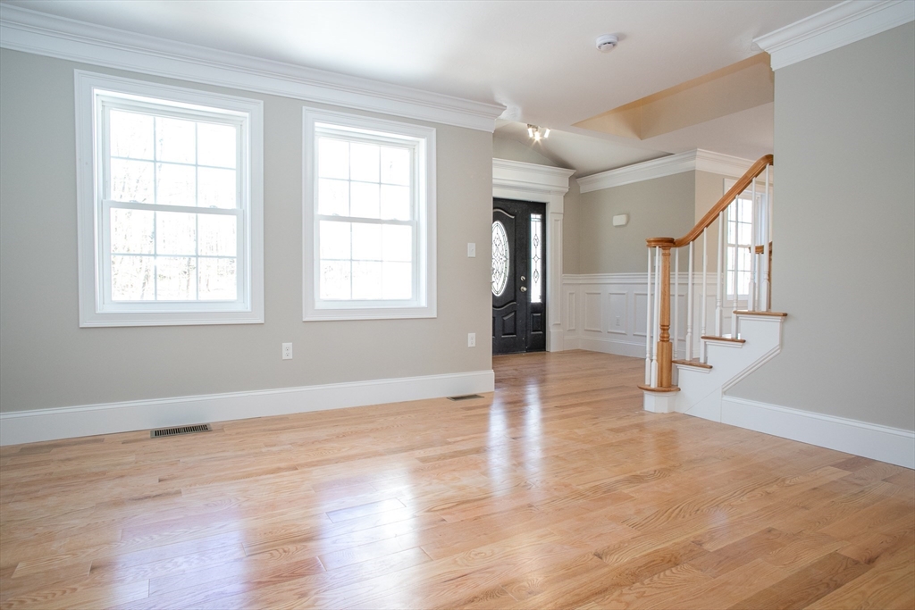 67 Willard Road Ashburnham, MA 01430 - Photo 8 of 42 an empty room with wooden floor and windows
