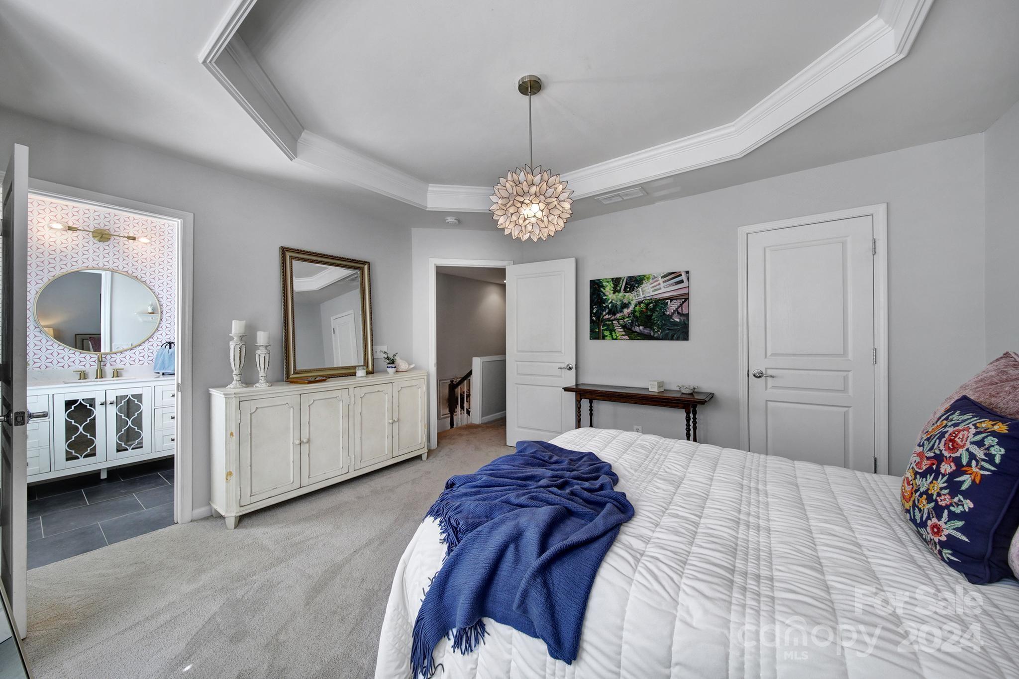 726 Passage Drive Fort Mill, SC 29708 - Photo 19 of 43 a bedroom with a bed and a chandelier