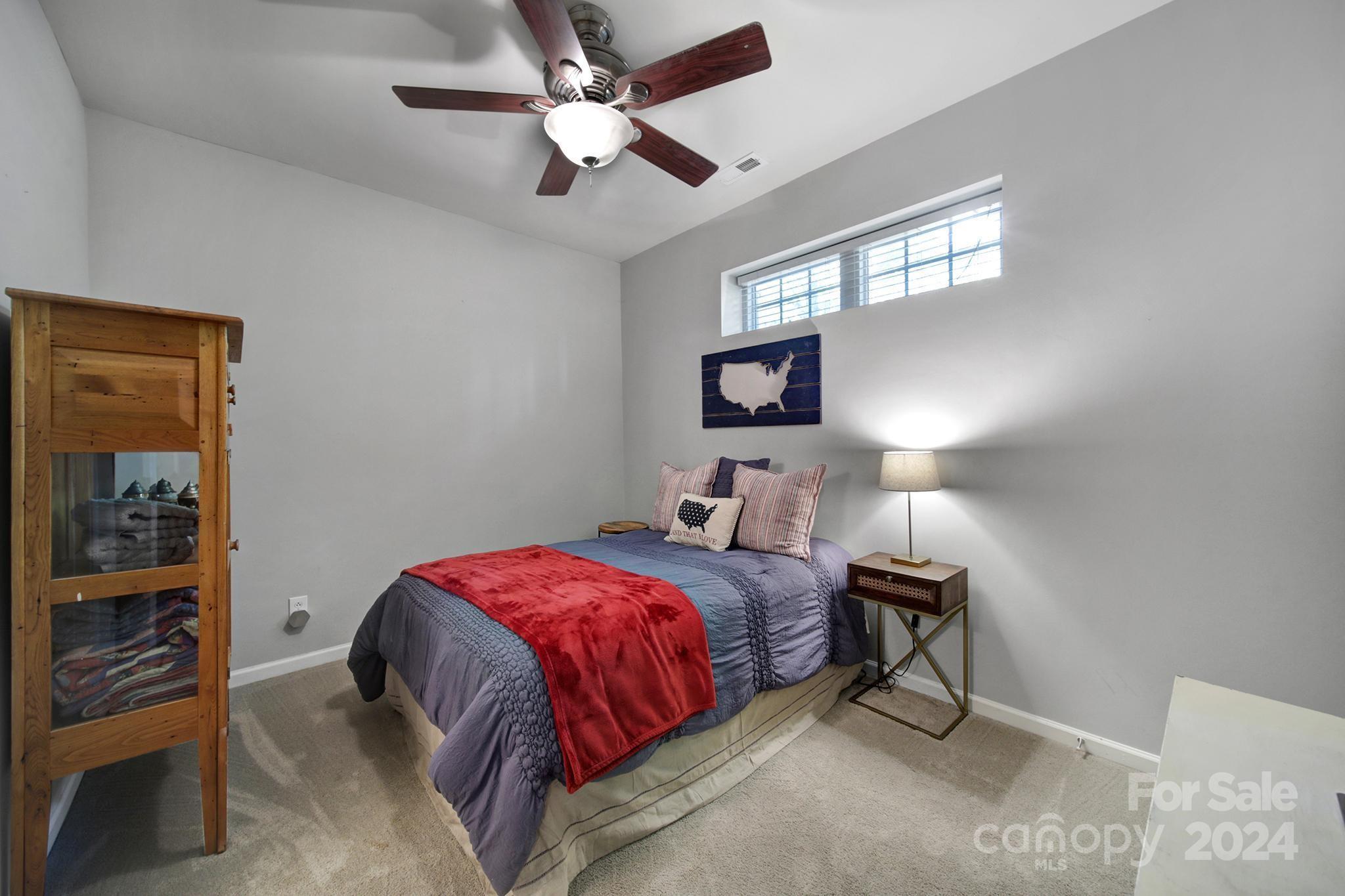 726 Passage Drive Fort Mill, SC 29708 - Photo 23 of 43 a bedroom with a bed and a chandelier