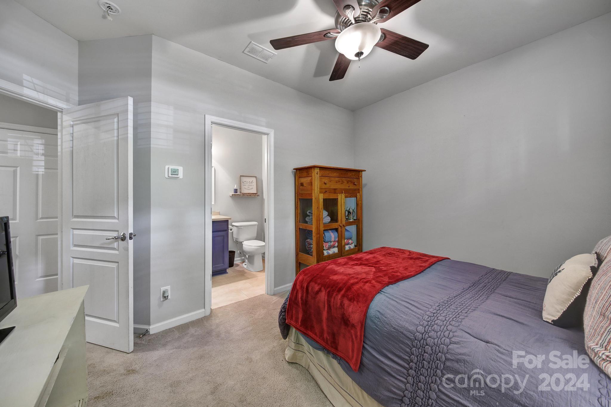 726 Passage Drive Fort Mill, SC 29708 - Photo 24 of 43 a bedroom with a large bed and a chandelier