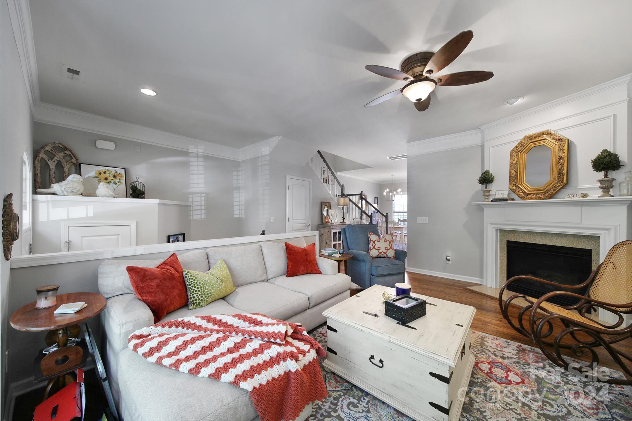 726 Passage Drive Fort Mill, SC 29708 - Photo 4 of 43 a living room with furniture a fireplace and a chandelier