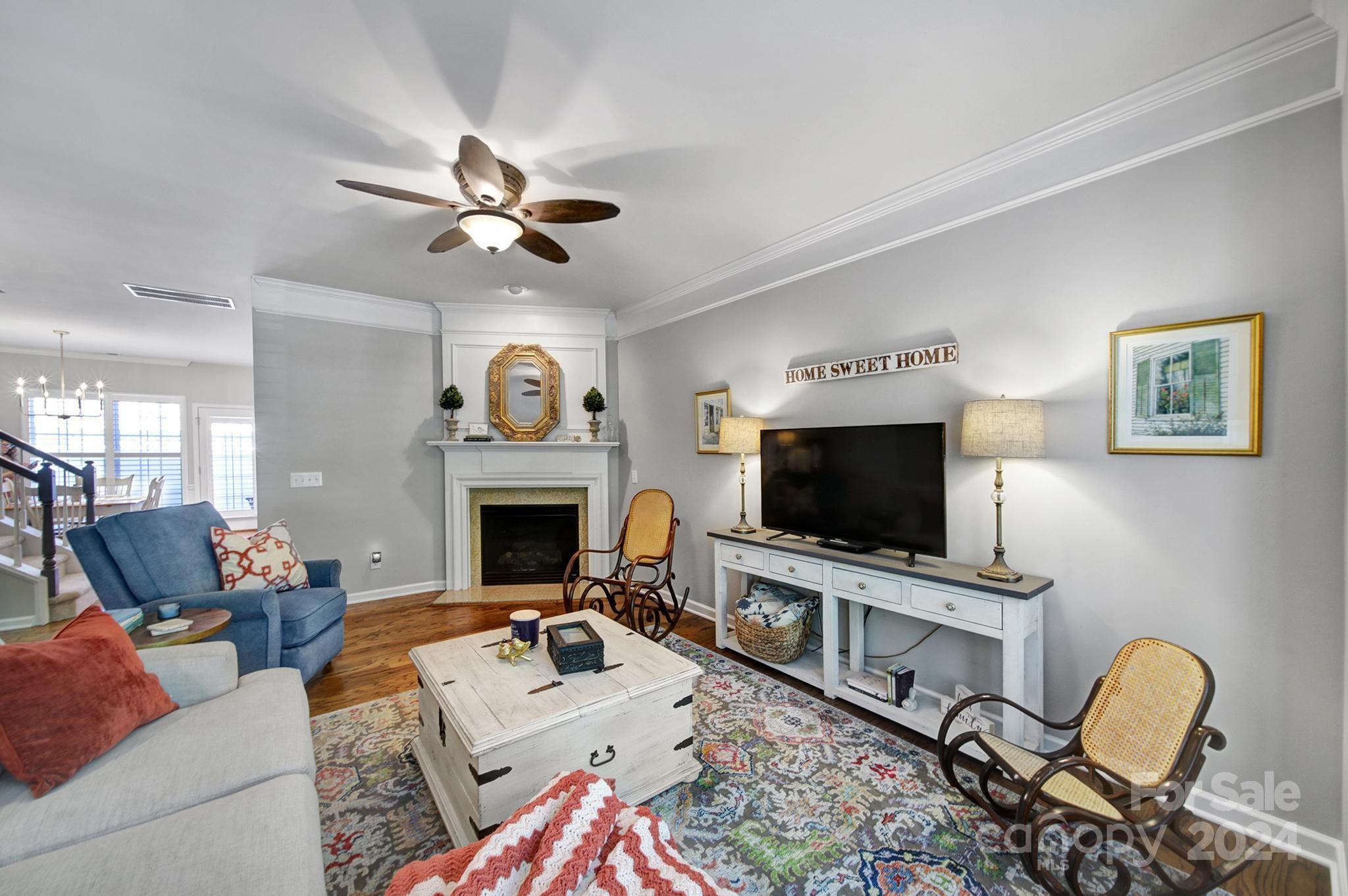 726 Passage Drive Fort Mill, SC 29708 - Photo 5 of 43 a living room with furniture a fireplace and a flat screen tv
