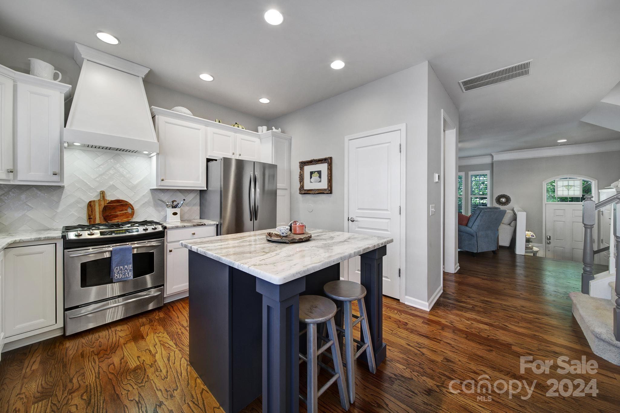 726 Passage Drive Fort Mill, SC 29708 - Photo 7 of 43 a kitchen with a stove a refrigerator and wooden floor
