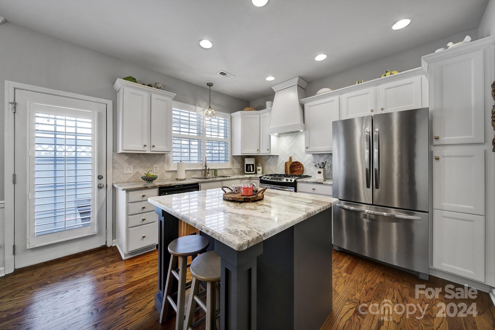 726 Passage Drive Fort Mill, SC 29708 - Photo 8 of 43 a kitchen with kitchen island granite countertop a sink appliances and cabinets