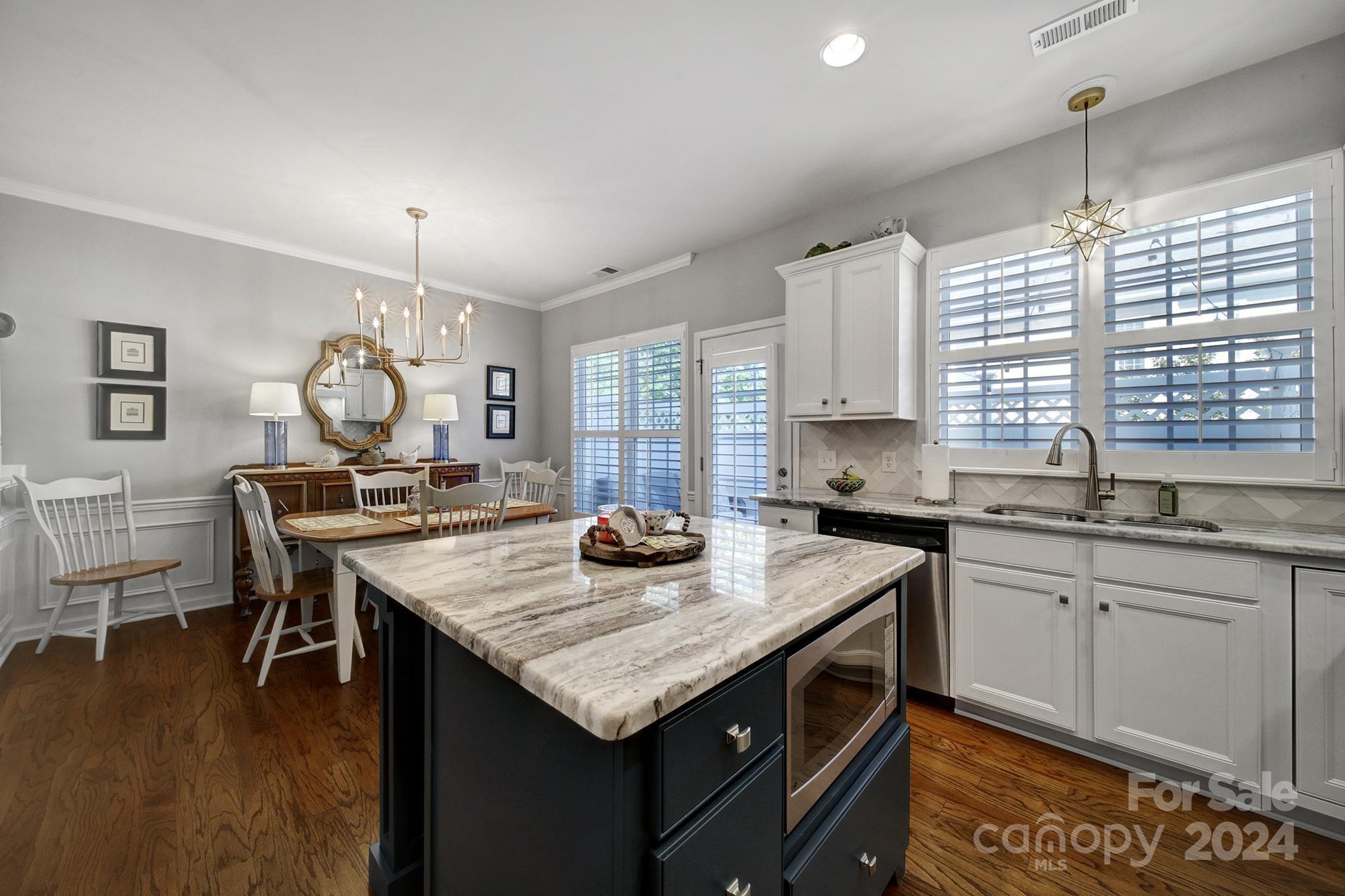 726 Passage Drive Fort Mill, SC 29708 - Photo 9 of 43 a kitchen with granite countertop a sink cabinets and wooden floor