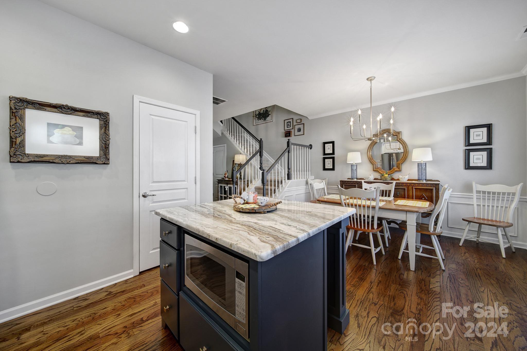 726 Passage Drive Fort Mill, SC 29708 - Photo 10 of 43 a kitchen with a table chairs and wooden floor