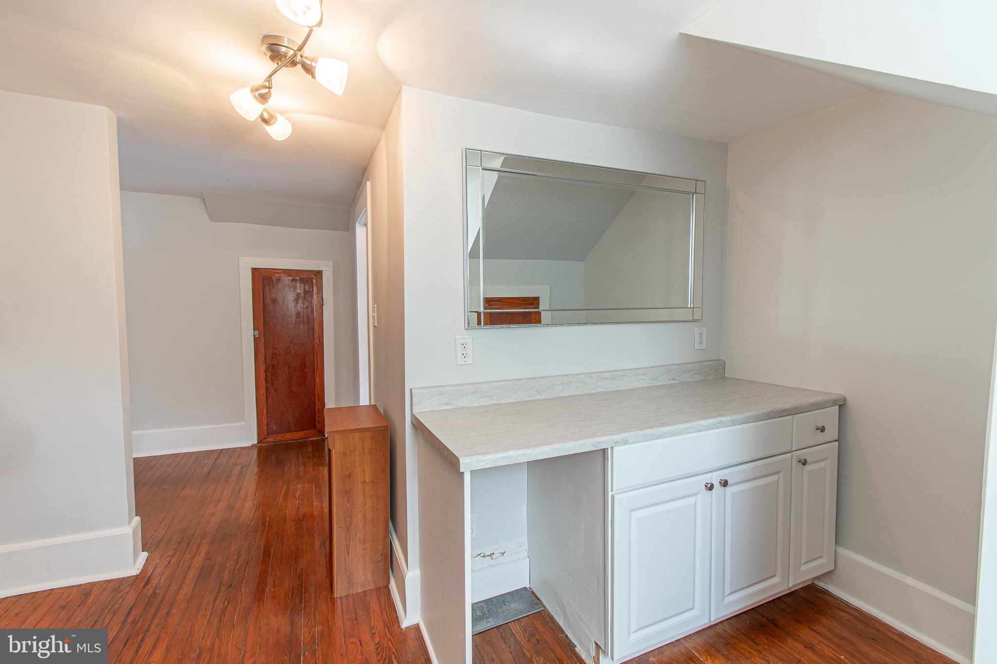 207 Crusader Road Cambridge, MD 21613 - Photo 55 of 76 a kitchen with a sink cabinets and wooden floor
