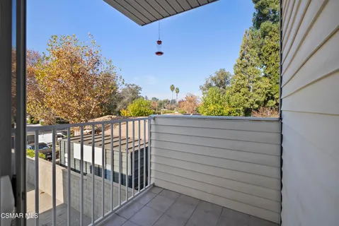 a view of a balcony with wooden fence