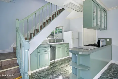 a kitchen with cabinets a counter and a stove