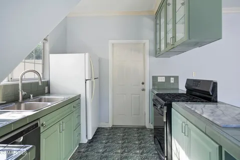 a kitchen with stainless steel appliances granite countertop a sink stove and refrigerator