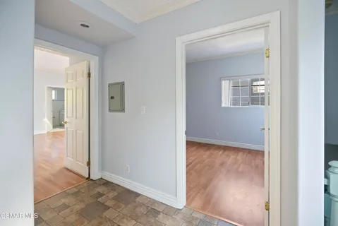 an empty room and mirror with shower
