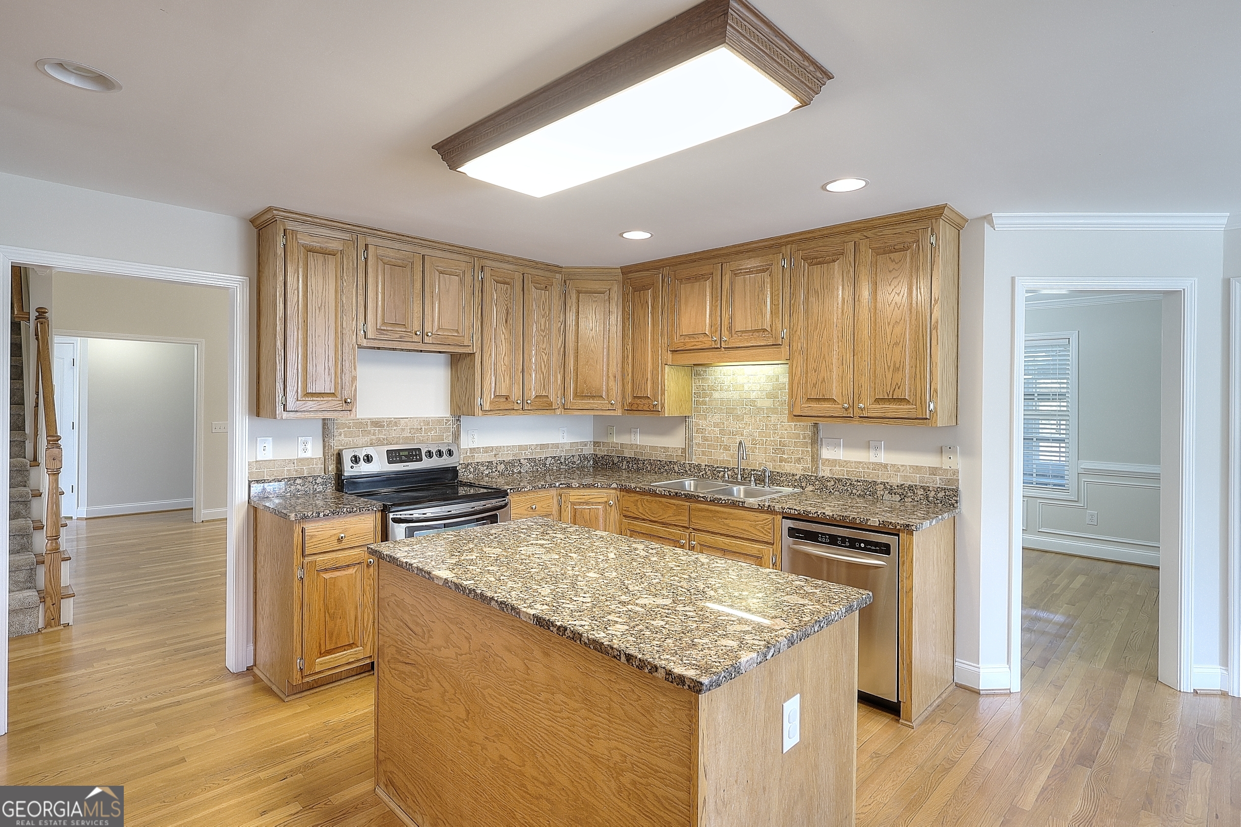 259 Hwy 11 Monroe, GA 30655 - Photo 13 of 19 a kitchen with a stove a refrigerator and a sink