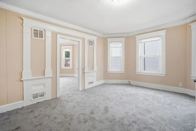 an empty room with windows and closet