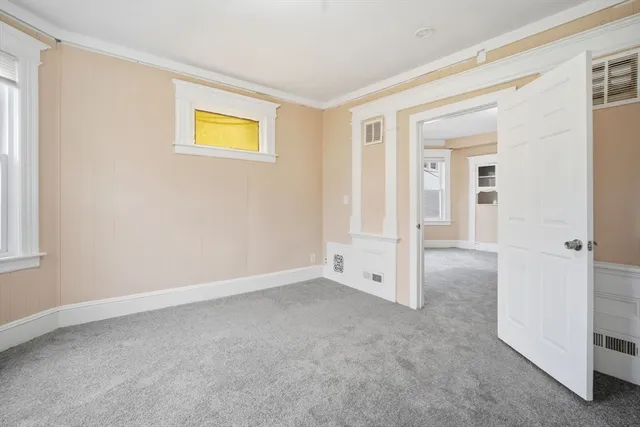 an empty room with windows and closet