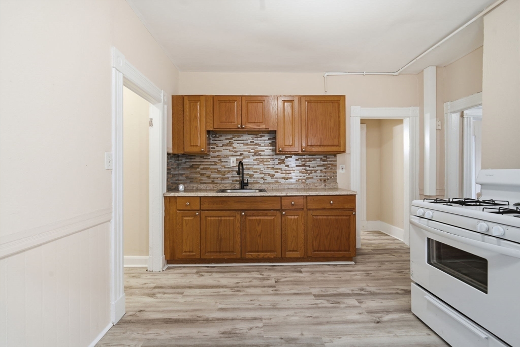 201 Main Street Springfield, MA 01108 - Photo 4 of 25 a kitchen with stainless steel appliances granite countertop a stove a sink and a refrigerator