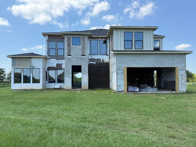 a view of a yard in front of a house with a large tree