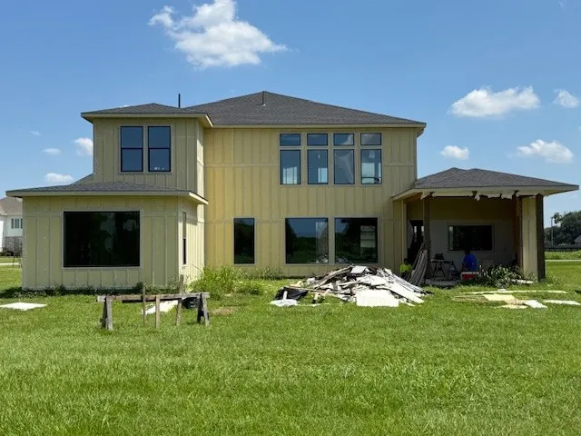 a backyard of a house with table and chairs