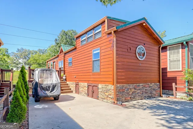 a backyard of a house with potted plants and a bench