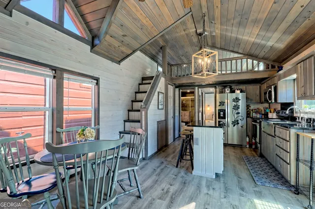 a view of a kitchen with refrigerator and windows