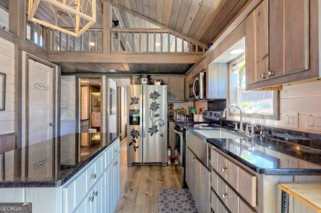 a kitchen with stainless steel appliances granite countertop a stove and cabinets