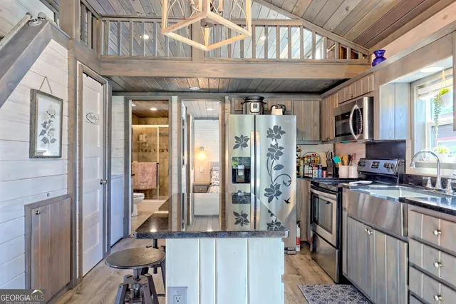 a bedroom with a large bed and a view of bathroom