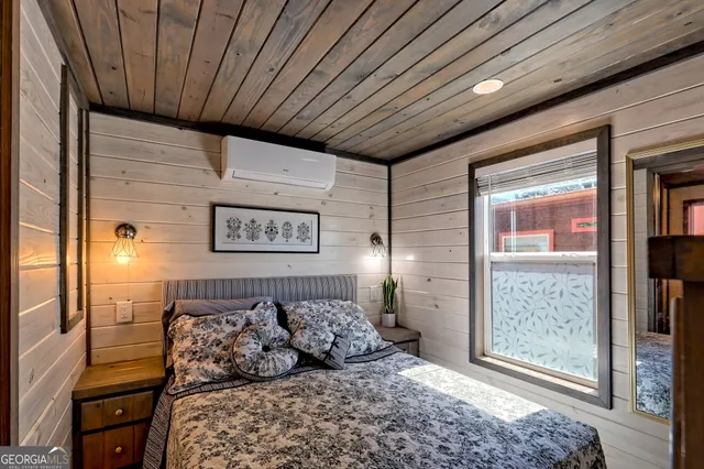 a bathroom with a granite countertop toilet sink and mirror