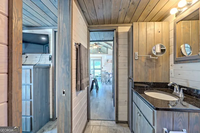 a view of a hallway with wooden floor and furniture