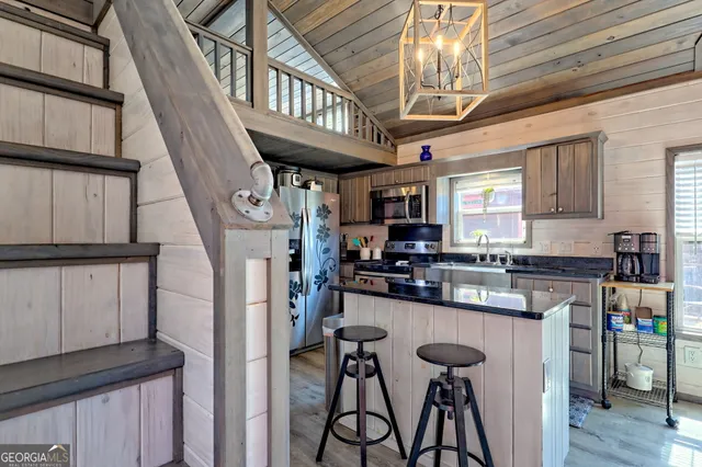 a view of a room with wooden floor and furniture