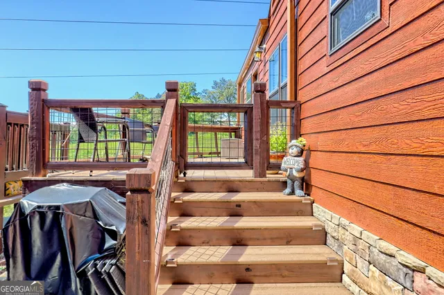 a view of a balcony with chair and wooden floor