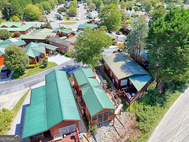 an aerial view of a swimming pool with a yard