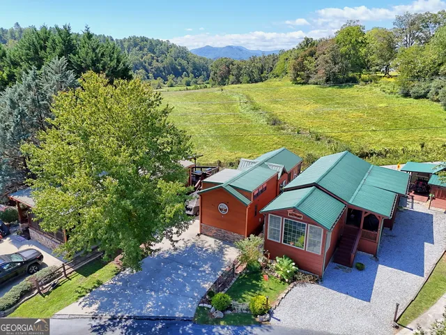 an aerial view of a house with a yard