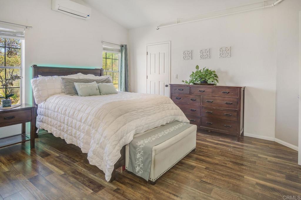 3465 Barrett View Road Alpine, CA 91901 - Photo 11 of 36 a bed sitting in a spacious bedroom next to a window and dresser