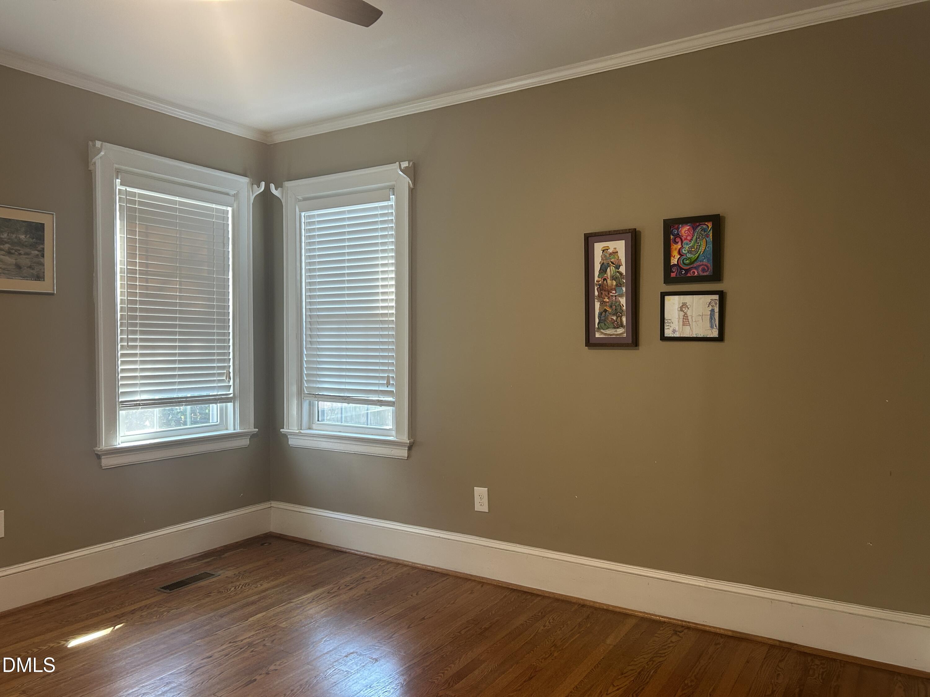 405 Sunset Avenue Clinton, NC 28328 - Photo 17 of 47 a view of an empty room with wooden floor and a window