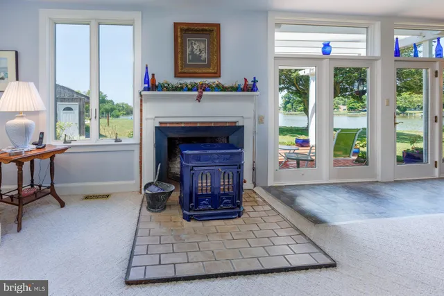 a dining room with furniture large windows and a chandelier