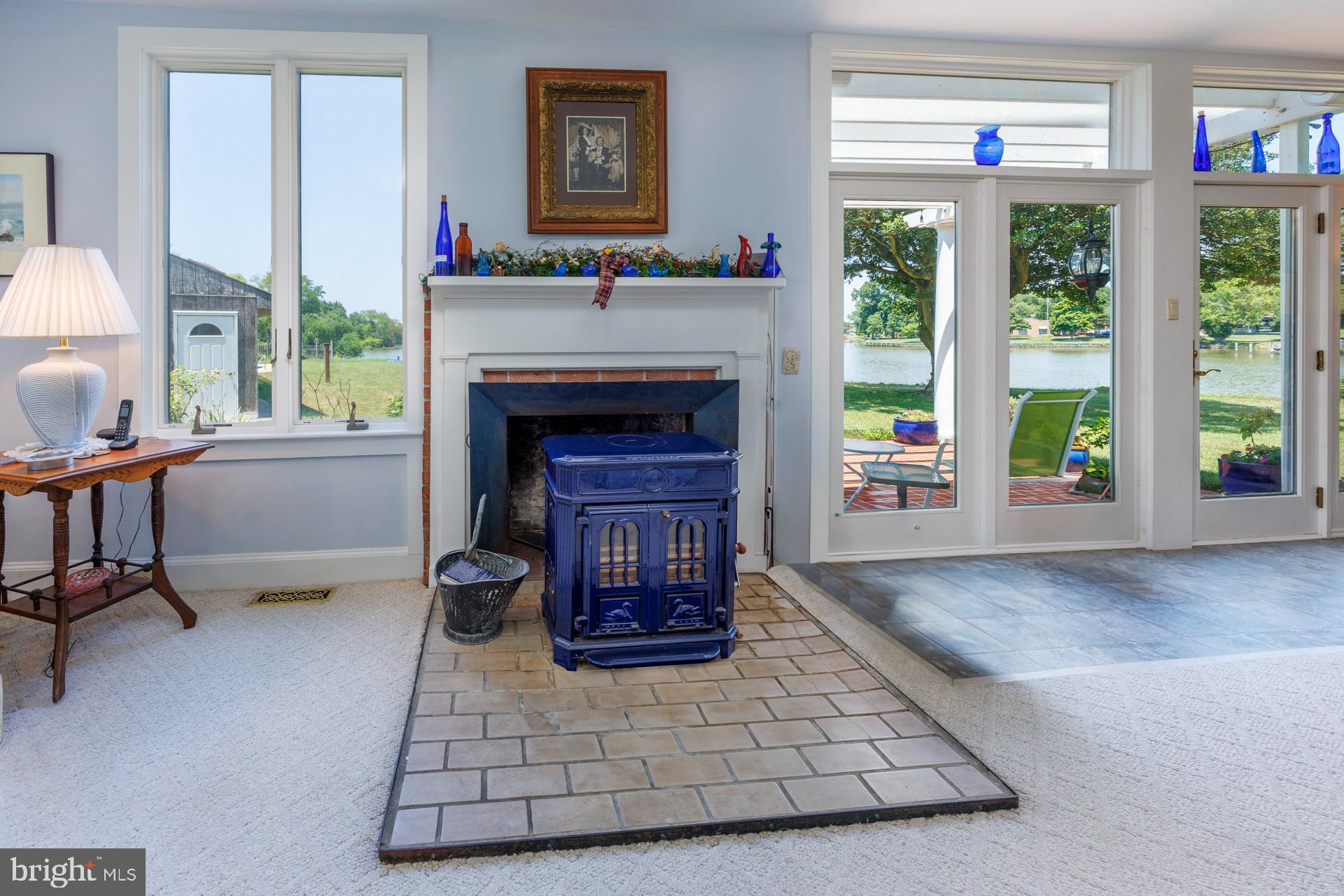 2208 Horns Point Road Cambridge, MD 21613 - Photo 23 of 61 a living room with furniture and a fireplace