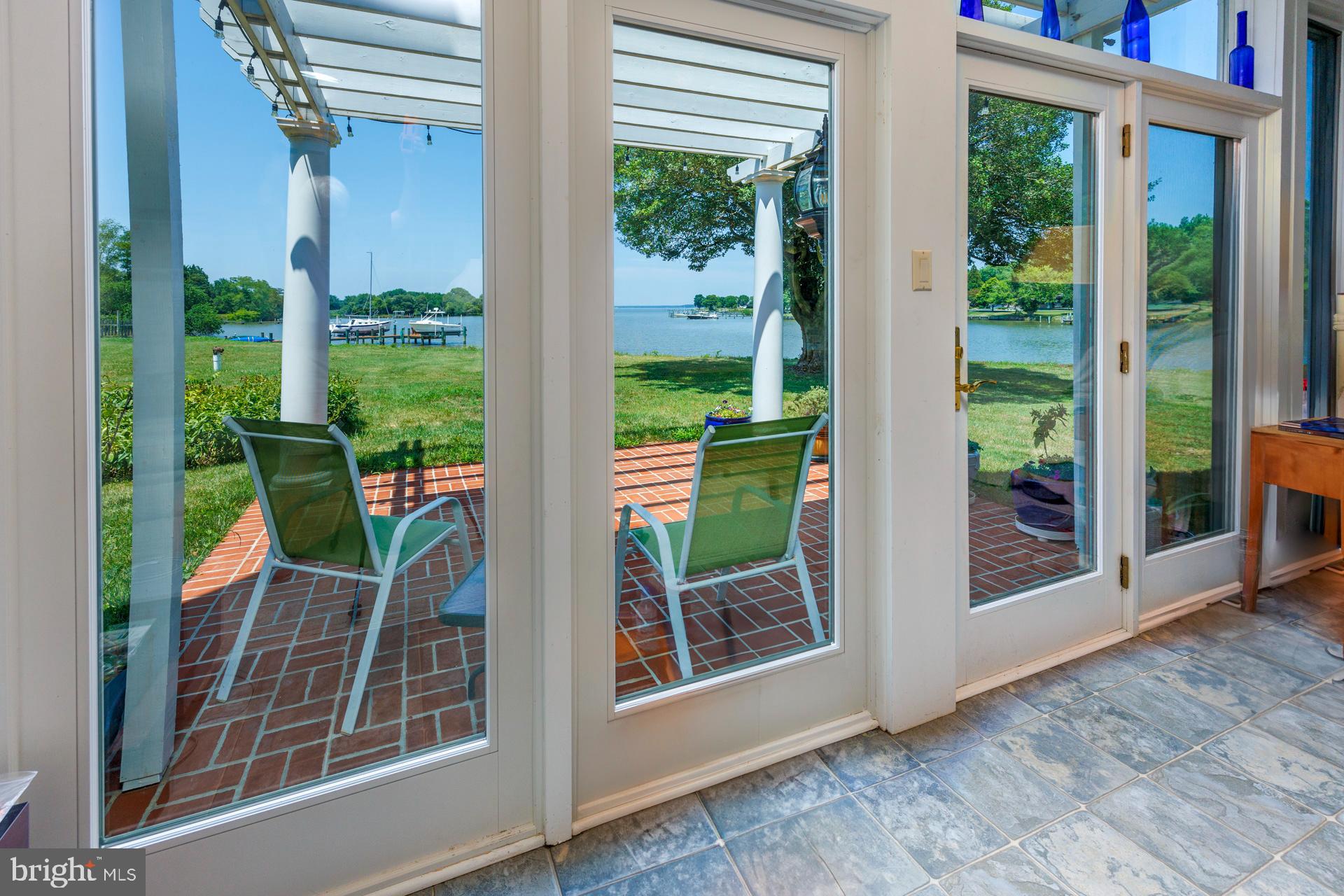 2208 Horns Point Road Cambridge, MD 21613 - Photo 25 of 61 a view of a porch with a table and chairs
