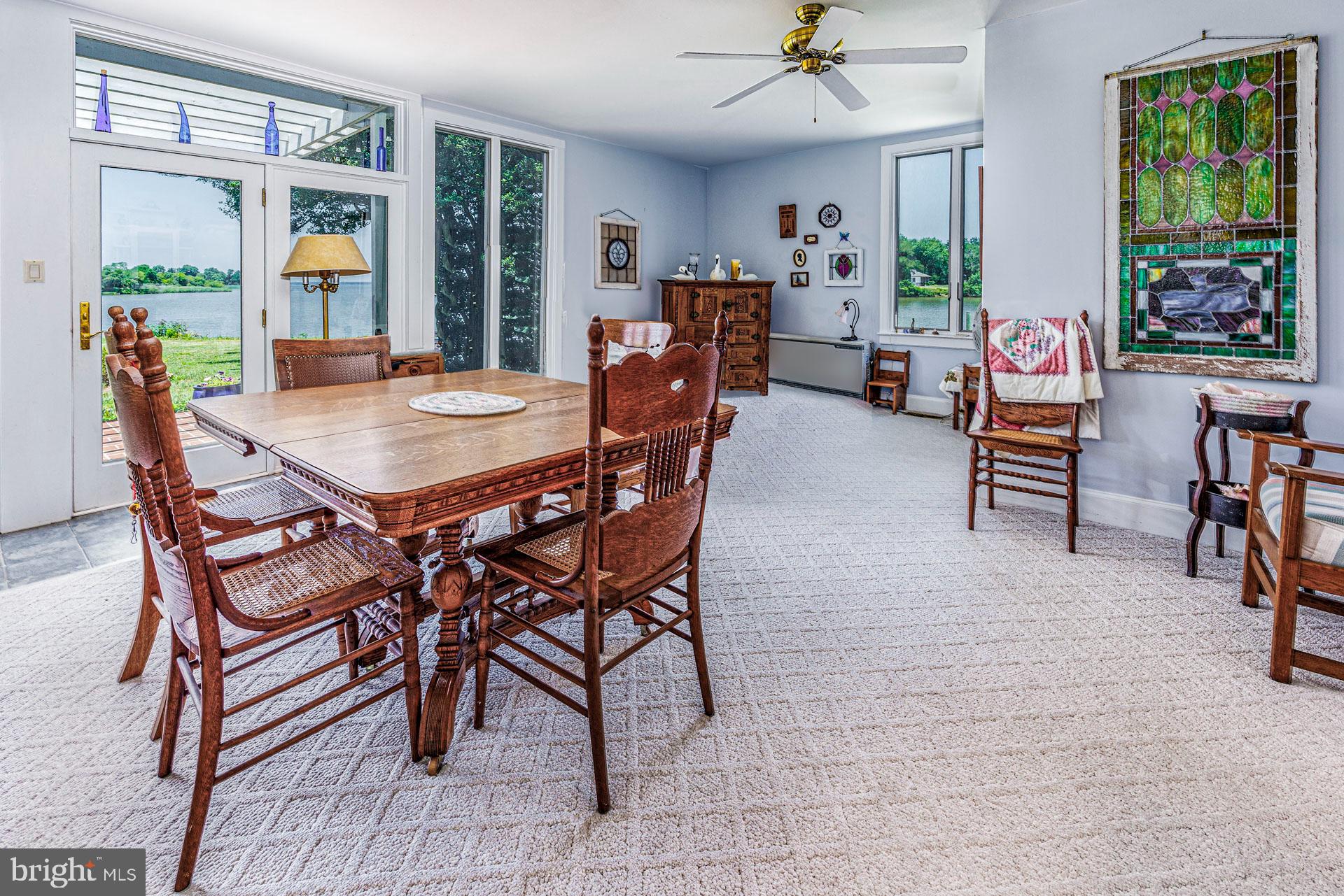 2208 Horns Point Road Cambridge, MD 21613 - Photo 26 of 61 a view of a dining room with furniture window and outside view