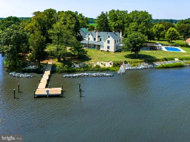 an aerial view of a house with a garden and swimming pool